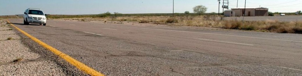 long lens photo of van on rural desert highway